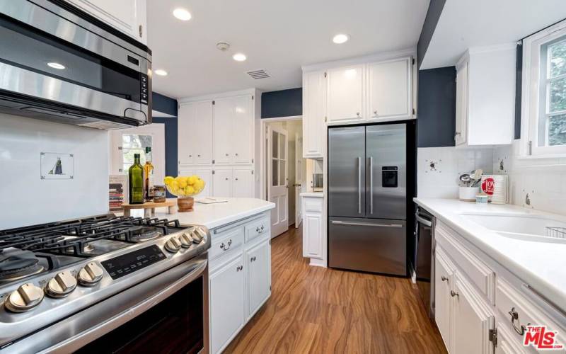 Great cabinet space, charming tile work & stainless steel appliances