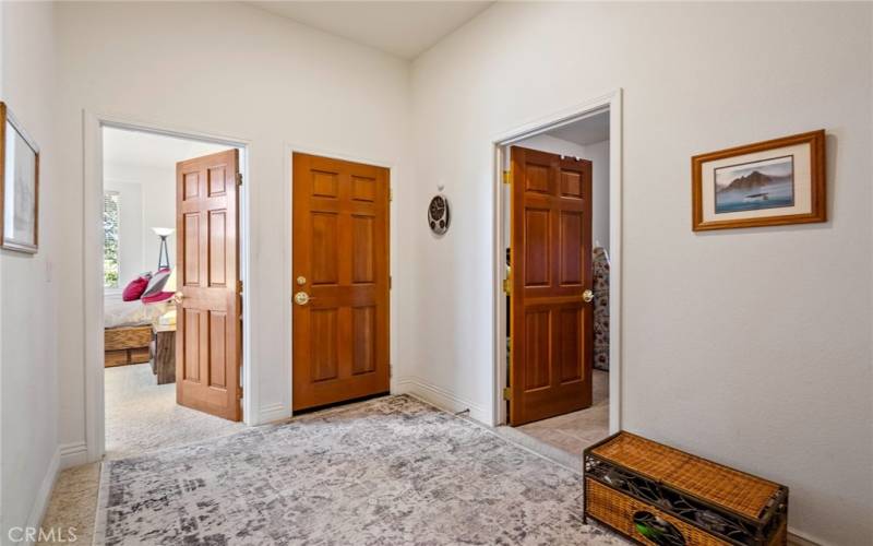 At the end of the hallway there is a small landing area. From left to right the doors are to bedroom 4, entrance to garage, laundry room and bathroom 3.