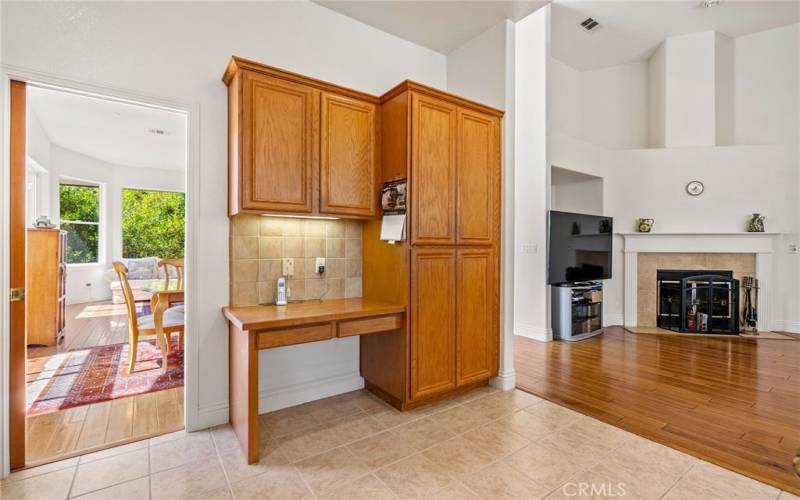 The kitchen offers abundant cabinetry for storage and a built in desk area.