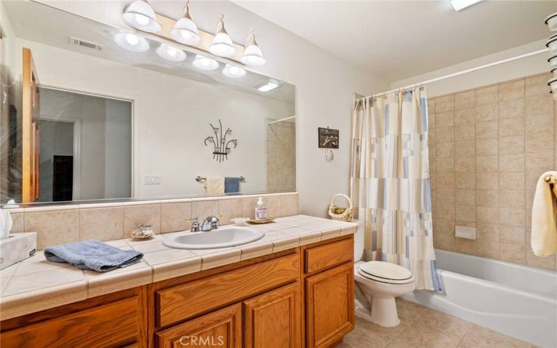 At the front of the hallway is the main bathroom with tile countertops, tiled floors and a tub/shower combo.