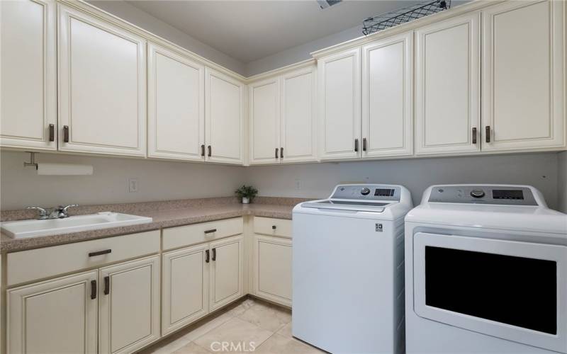 Laundry Room adjacent to the Kitchen & Garage