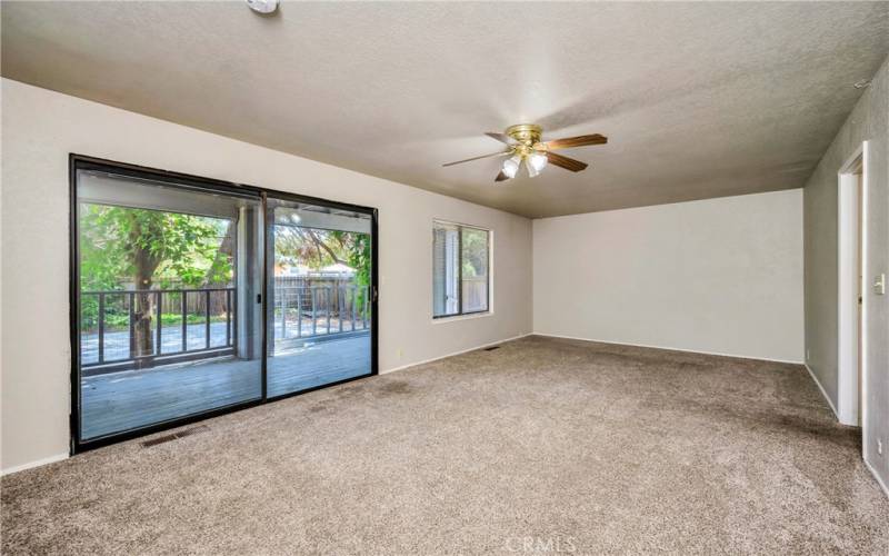 Living area on rear of house opens to covered deck and patio.