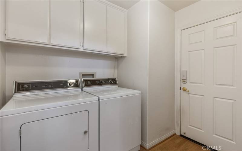 The laundry room where you have hook ups for either gas or electric dryers. The door to the right leads to the two car garage with golf cart tandem parking.