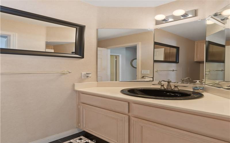 The downstairs guest bath is a 1/2 bath with updated flooring and fixtures.