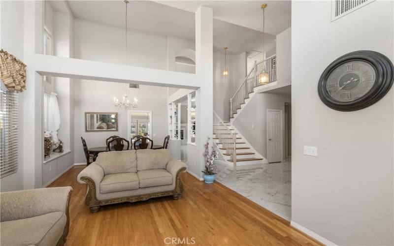 The open floor plan leads tot he stairs, or into the kitchen and family room beyond.