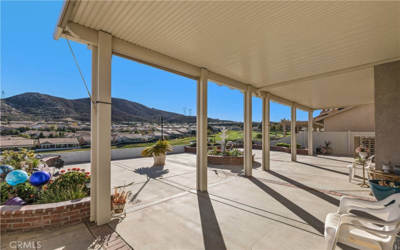 The backyard patio is a lovely place to enjoy the outdoors. The alumawood shade structure runs the entire length of the home. The views are lovely!