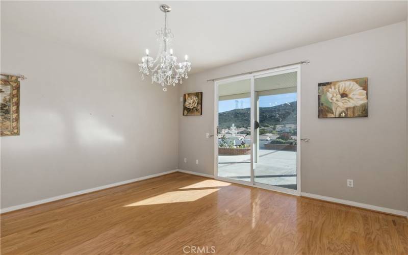 The bedroom also has oak wood floors and vaulted ceilings. There is plenty of natural light from the windows and the sliding door.