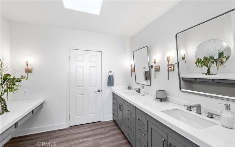Renovated primary bath with dual sinks and vanity.