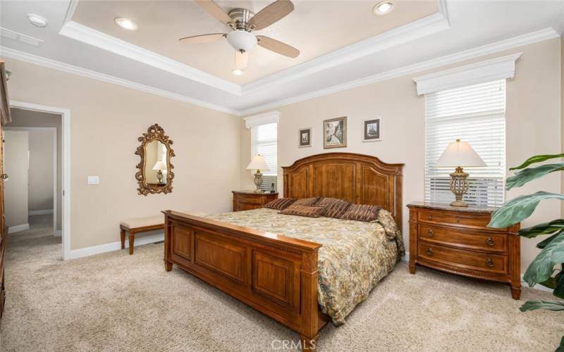 Master bedroom offers coffered ceiling with recessed lights and ceiling fan.