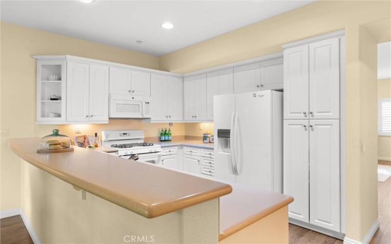 Light & bright kitchen - chic white cabinets and appliances and Eating Bar gives you a casual dining area.