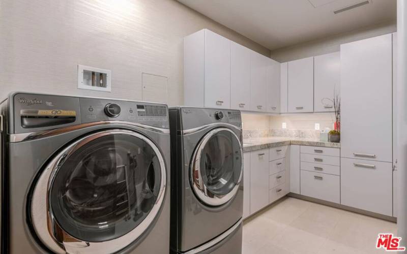 Extra-large walk in laundry room with storage
