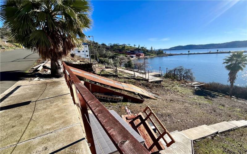 View of parking pad and Lily Cove