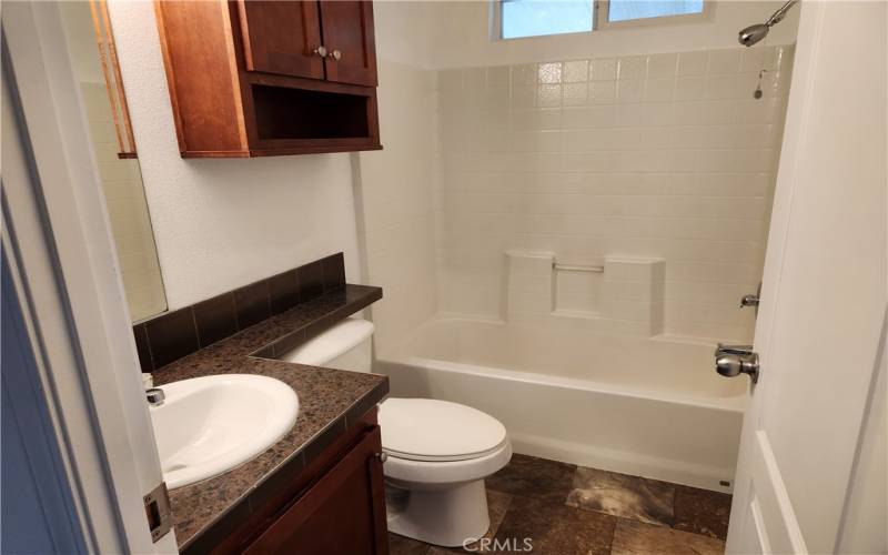 Enter into the 2nd bathroom Tub/Shower combo located next to bedrooms 2 & 3