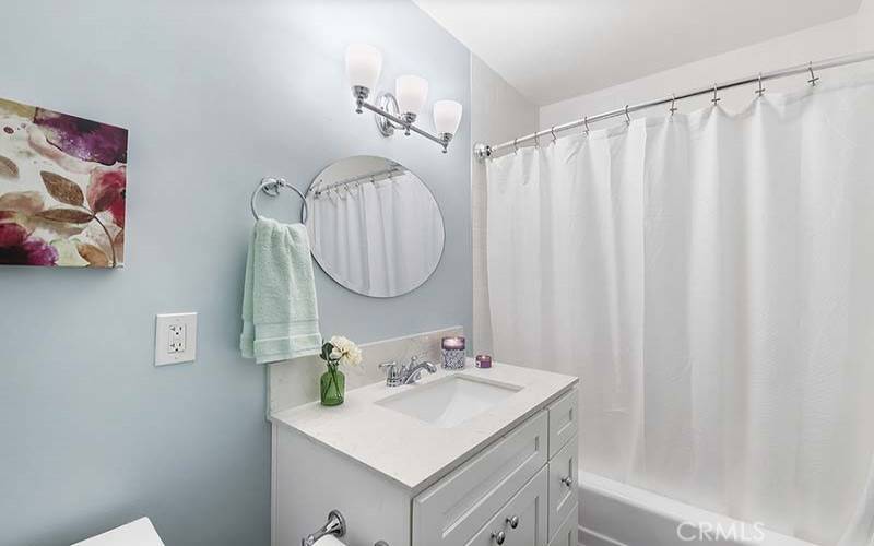 Guest powder room with tub and shower combo. Quartz counter tops!
