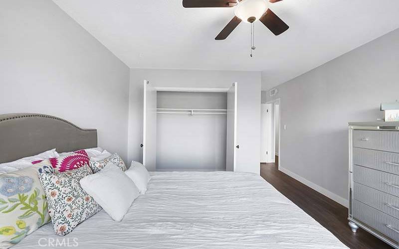 Master suite has a ceiling fan with smooth plaster walls
