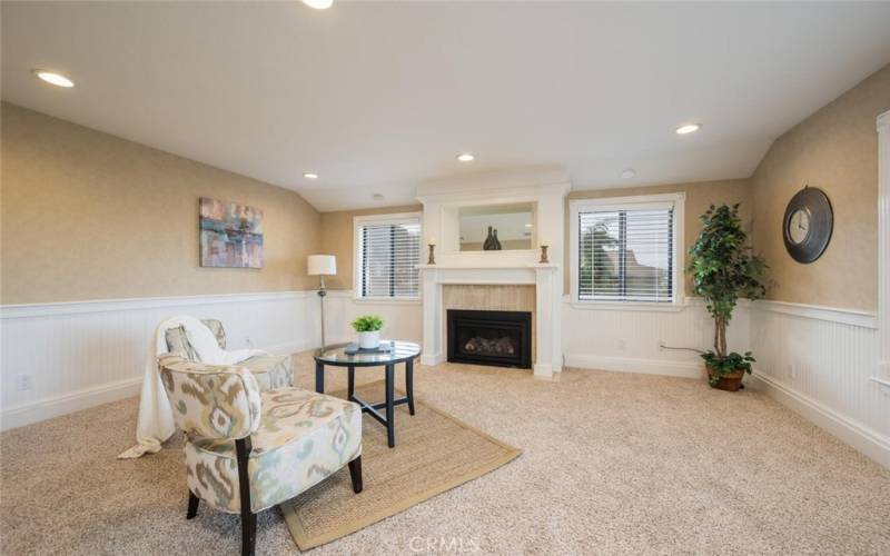 Family room with cozy fireplace, located near front door.