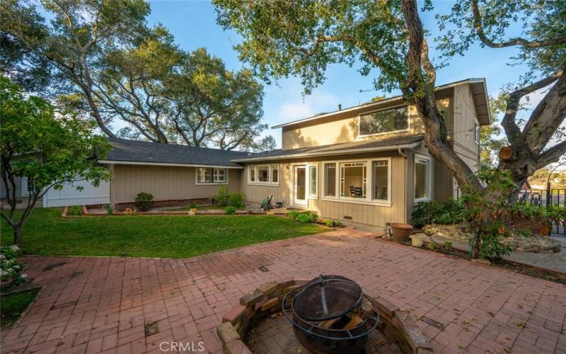 Enjoy  a spacious backyard, with mature Oak trees, a fruiting mandarin orange tree,  a fruiting apple tree, mature landscaping, and a fire pit. This backyard is truly your own private getaway!