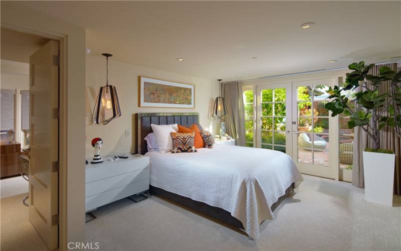 Gracious main level en suite bedroom with separate entrance, accessible from front courtyard.