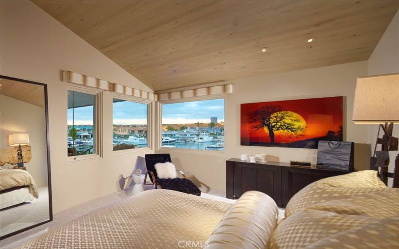 Oversized master bedroom with stunning views, peaked exposed wood ceilings, private deck, and sumptuous master bath and dressing area.