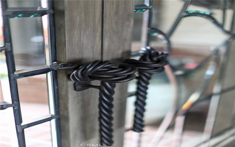 Custom, wrought-iron knot detail door pulls.
