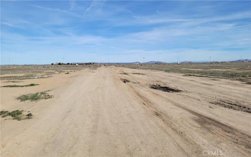 Dirt road connecting property to main paved road