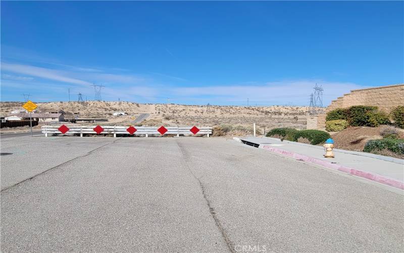 Rancho Rd. Looking West at the property boundary at the end of the Brick wall