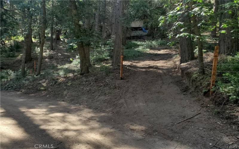 This Driveway is shared right now but can be divided easily, since it's still just dirt.