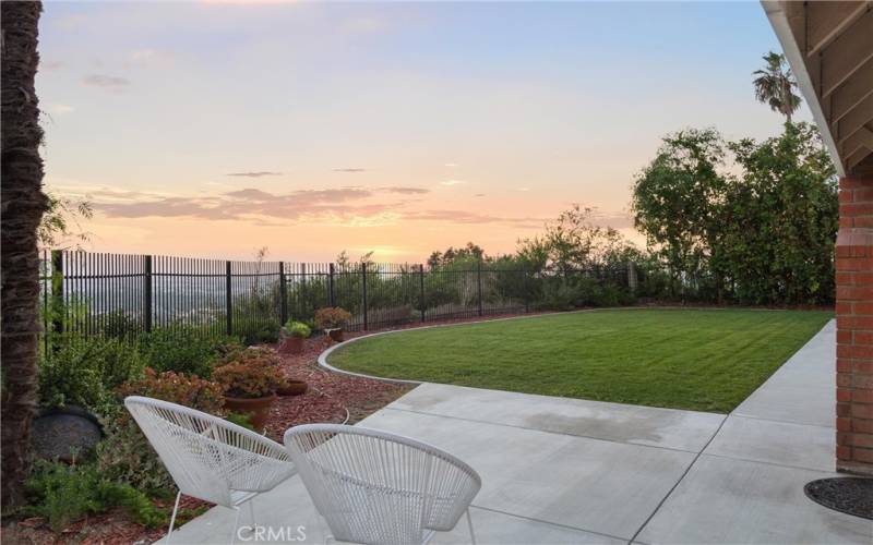 sliding doors lead to large flat grassy yard with epic views