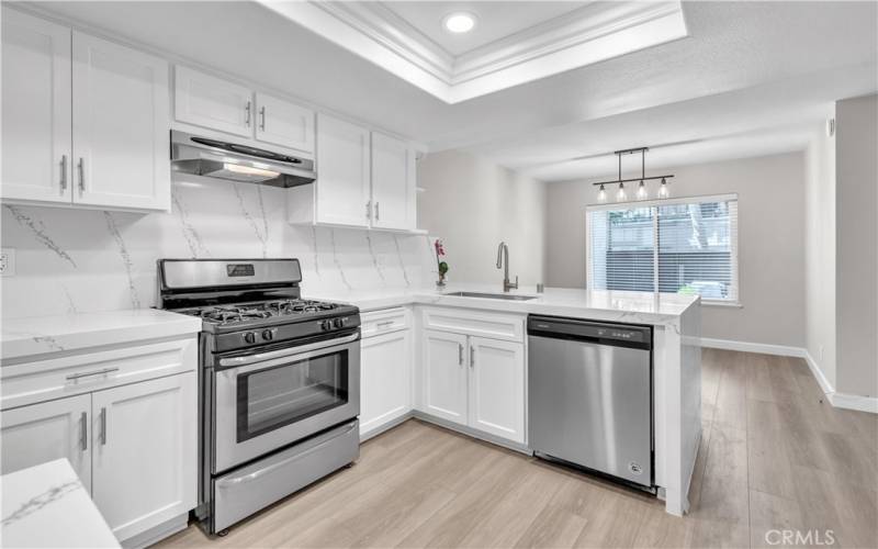 Upgraded Kitchen includes Quartz Marble Countertops with Waterfall Design.  Open to the Dining Area.