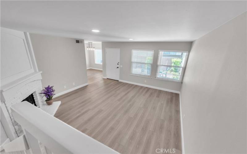 View from Stairs overlooking Spacious Living Room with Upgraded Smooth Ceilings.