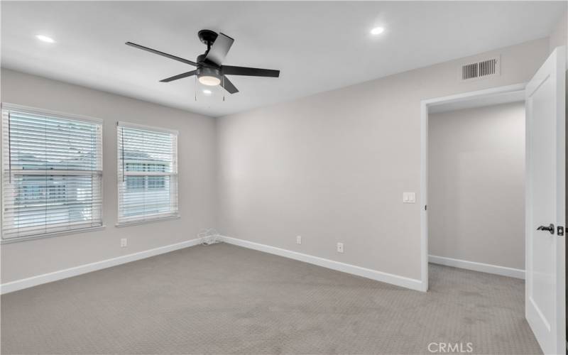 The Primary Bedroom includes Brand New Designer Carpet, New Interior Paint, New Ceiling Fan, and New Recessed Lighting.