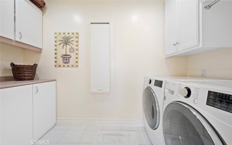 Laundry room with new washer/dryer and wall ironing board.