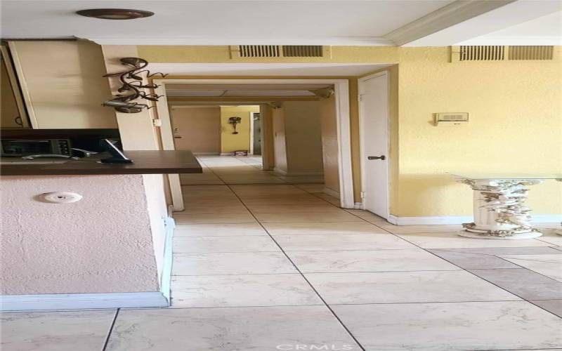 hallway leading to bedroom, extra coat closet and bathroom