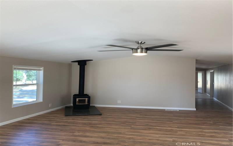 LIVING ROOM AND WOOD STOVE.  NEW CEILING FAN!