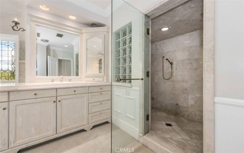 Primary master bathroom equipped with jacuzzi bathtun, walk in shower, his and her vanity areas, water closet and an additional large walk-in closet.