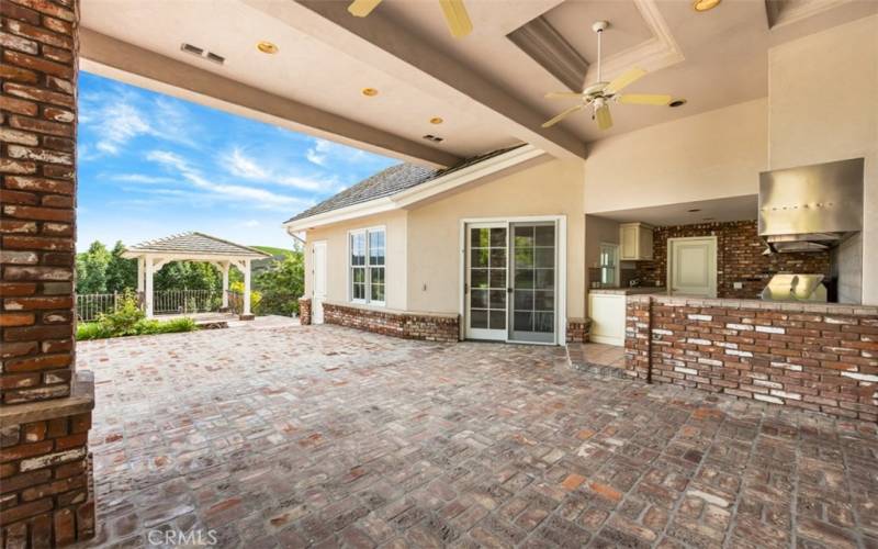 Entertainer’s backyard offers a custom barbecue and kitchen, entertainment pool/spa, large pool house with a full kitchen, lighted tennis court, all surrounded by beautiful horse property.