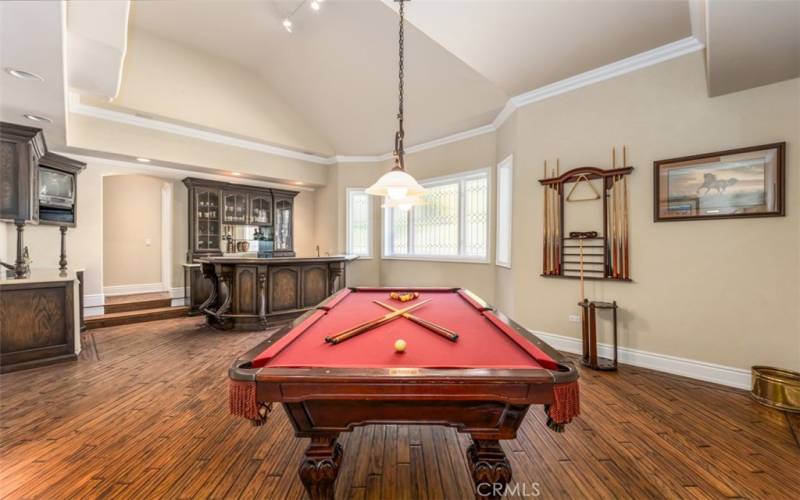 Oversized game room with built-in cabinets and a custom built-in bar with seating for​​‌​​​​‌​​‌‌​​‌​​​‌‌​​​‌​​‌‌​​‌‌​​‌‌​​​​ 8.