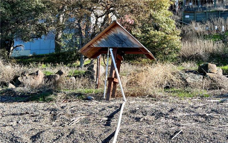 Water pipe & pump house that pulls water from the lake.