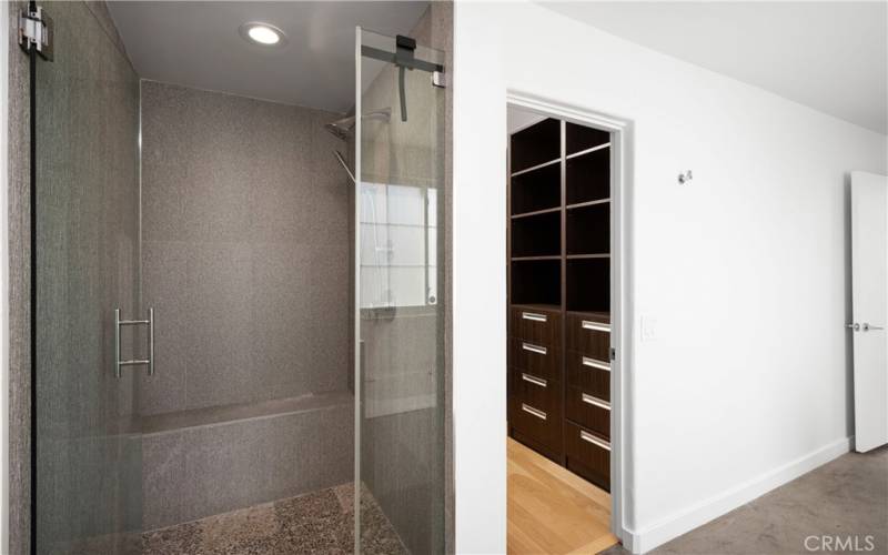 Shower and walk-in closet in primary suite's bathroom