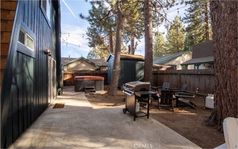 Beautiful Backyard W/Jacuzzi, BBQ, Seating area around Firepit W/Hanging lights. Home also includes a Backyard Shed.
