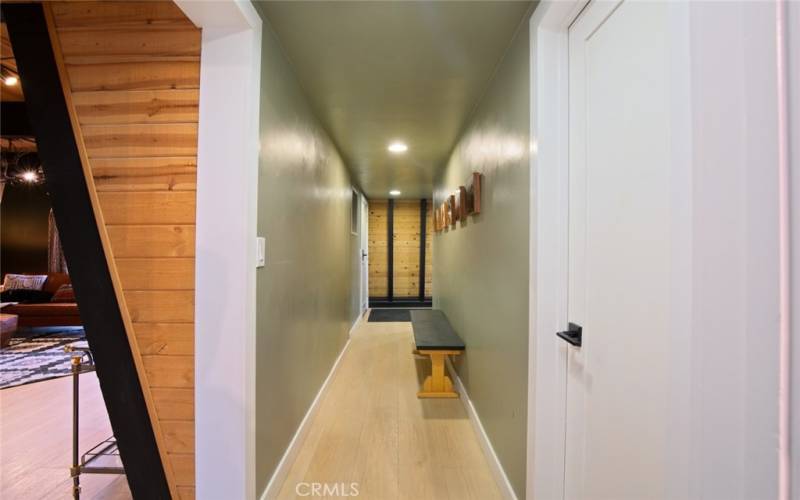 Hallway into living space from Entryway Mudroom.