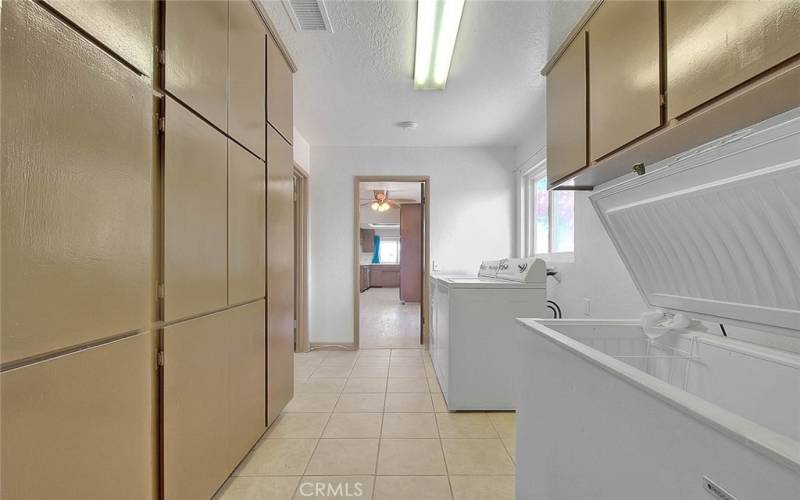 Laundry room with lots of built in cabinets