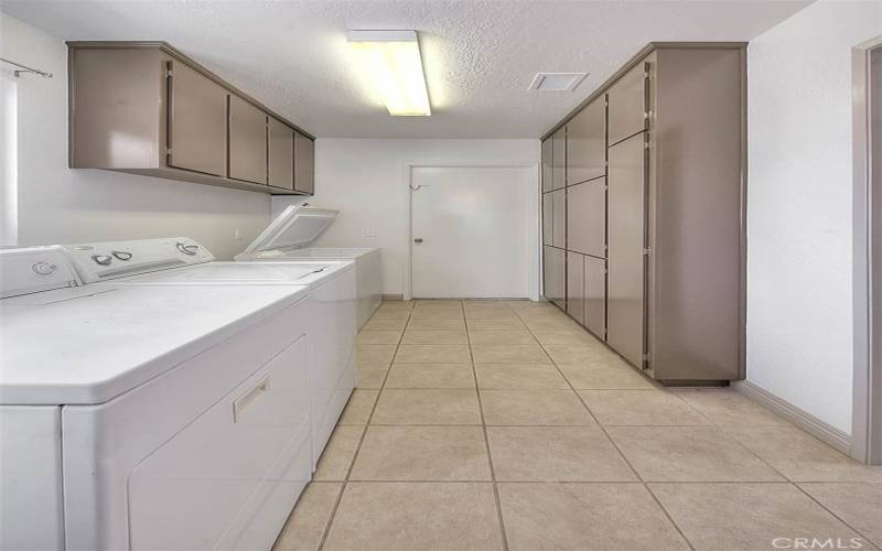 Laundry room off the Kitchen with built in cabinets