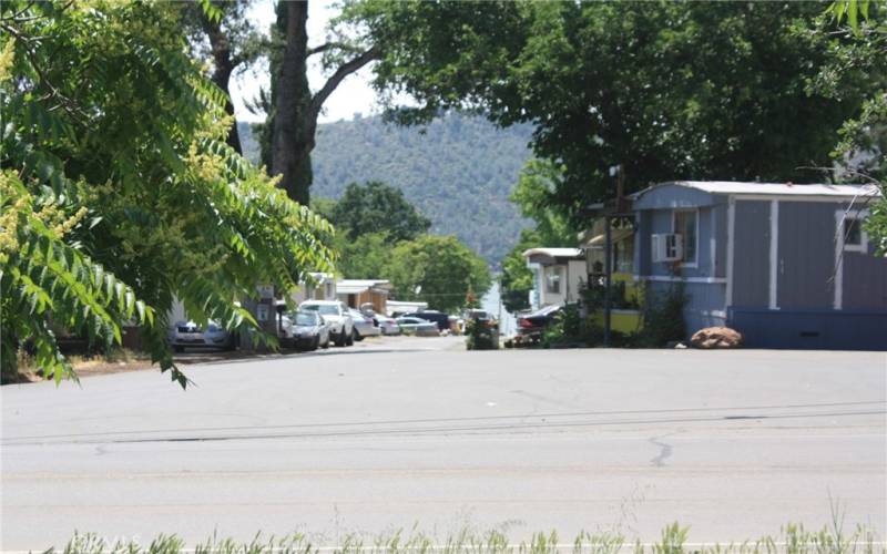 View from the back of the lot facing street. You can see a bit of the lake through the neighborhood