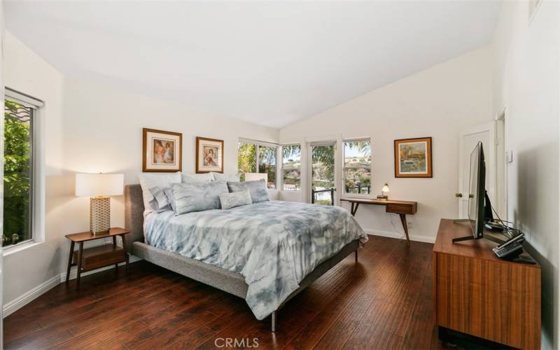 View of primary bedroom with ocean view balcony.