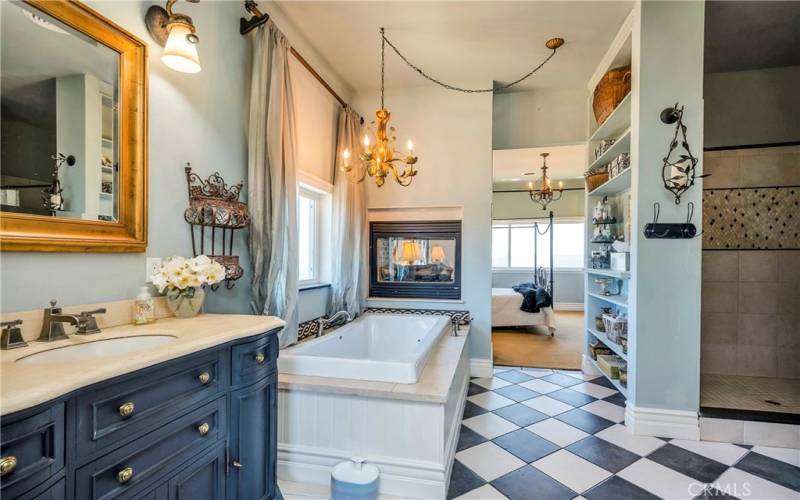 Double-sided fireplace at the foot of the soaking tub.