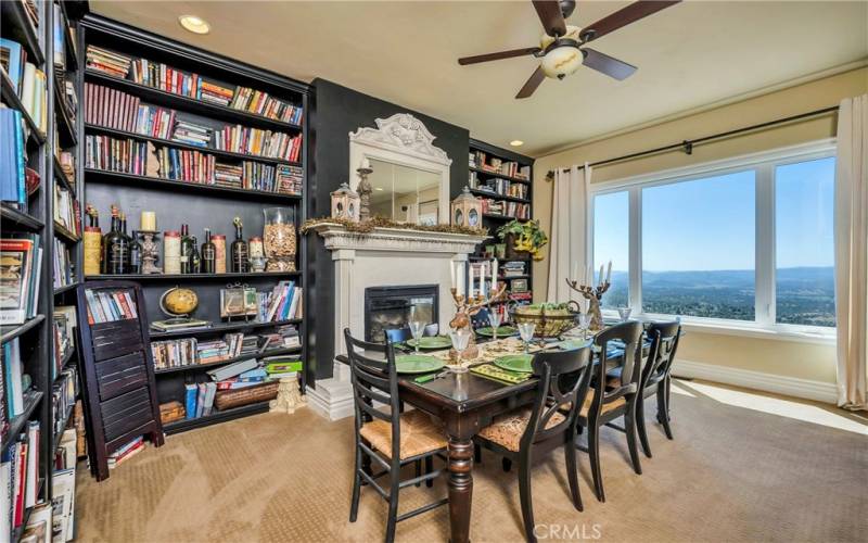 The dining room doubles as a library, with gas fireplace and commanding views of the surrounding hills.