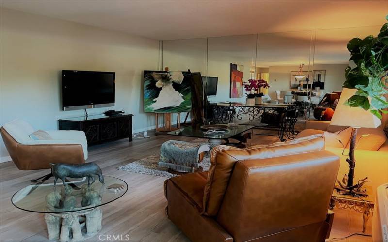 Spacious living room with flat screen TV and original art pieces.
