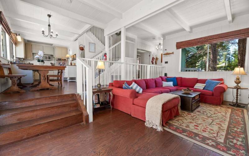 view of family room and kitchen, stairs lead to upstairs rooms.