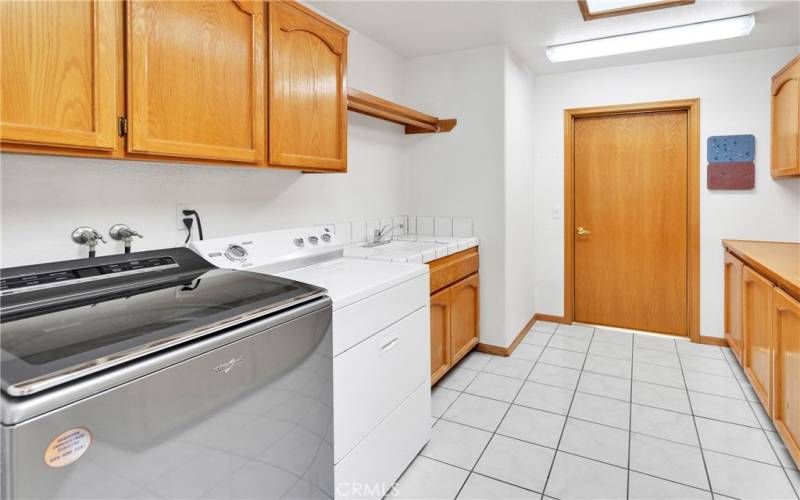Huge Laundry room with sink, storage and room for a fridge